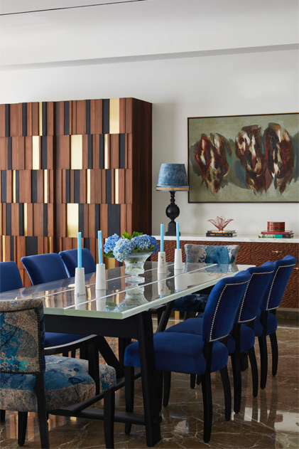 Glass top dining table with blue tufted chairs – Beautiful Homes